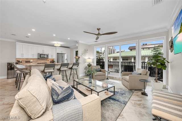 living room with ornamental molding and ceiling fan