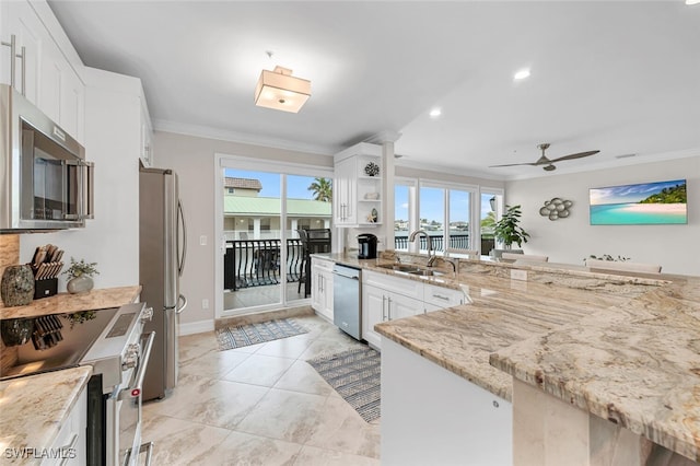 kitchen with sink, stainless steel appliances, crown molding, and white cabinets