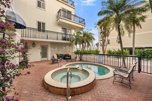 view of pool featuring a patio area and a hot tub