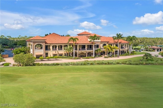 view of community with view of golf course and a lawn