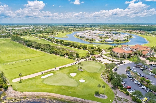 aerial view with a water view and view of golf course