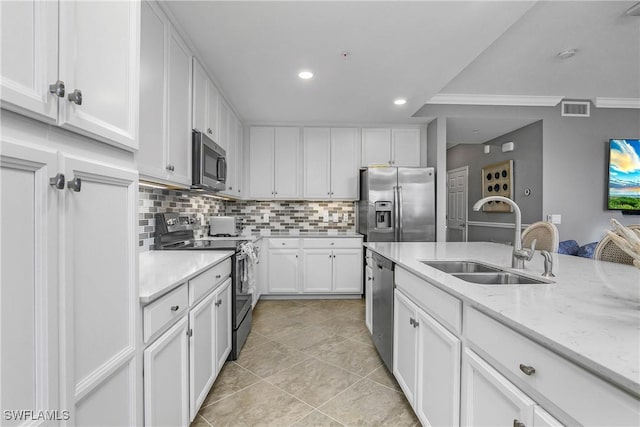 kitchen featuring light stone counters, stainless steel appliances, a sink, visible vents, and white cabinetry