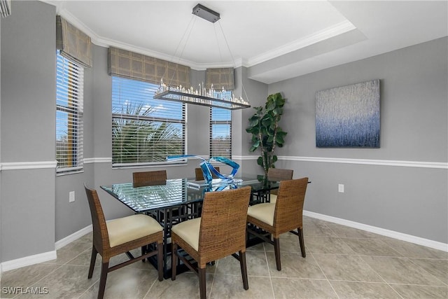 dining area with crown molding, baseboards, and a wealth of natural light