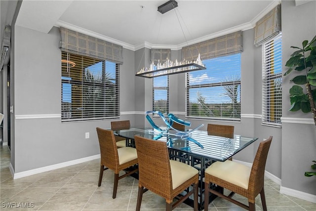 dining space featuring ornamental molding, baseboards, and light tile patterned floors