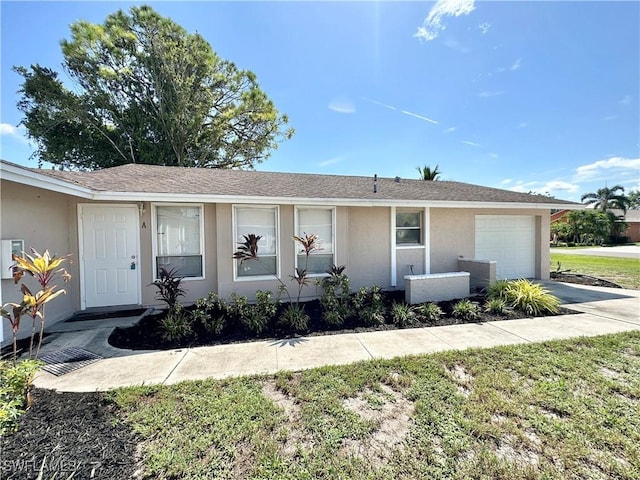 ranch-style house featuring driveway, a front lawn, an attached garage, and stucco siding