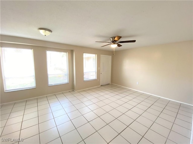 spare room featuring a ceiling fan and light tile patterned flooring