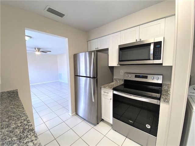 kitchen with white cabinetry, visible vents, appliances with stainless steel finishes, and light stone counters