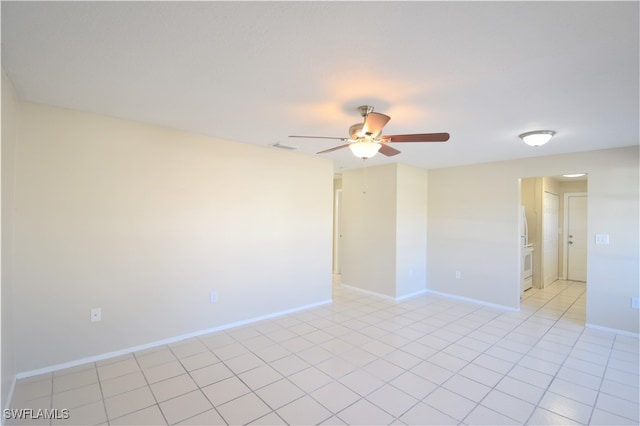 unfurnished room featuring light tile patterned floors, visible vents, a ceiling fan, and baseboards