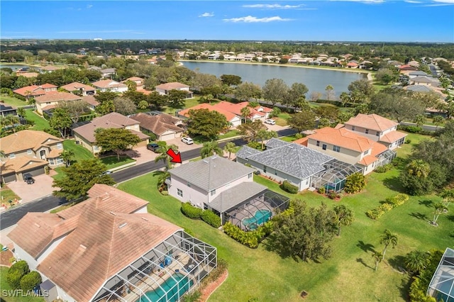 drone / aerial view featuring a water view and a residential view