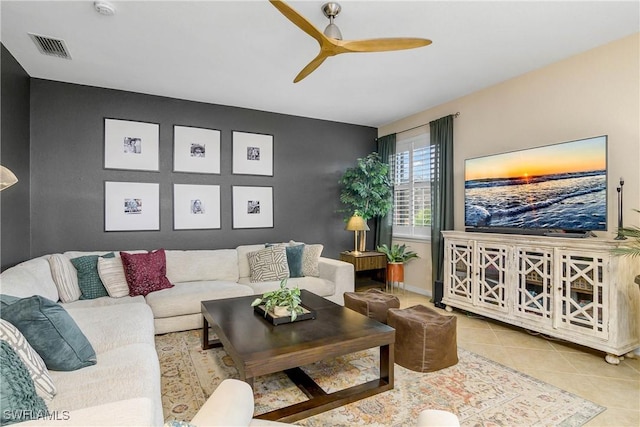 living area featuring ceiling fan, tile patterned flooring, visible vents, and baseboards