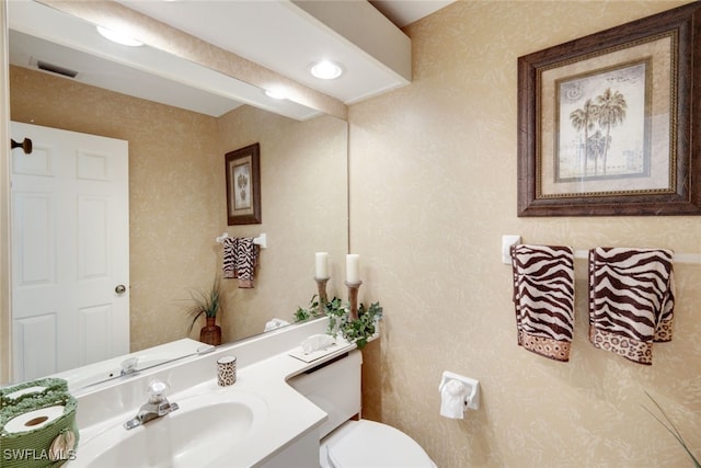 bathroom featuring vanity and toilet