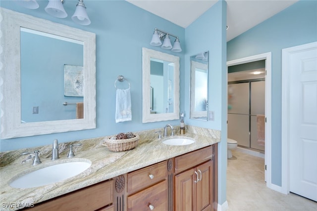 bathroom featuring an enclosed shower, vanity, and toilet