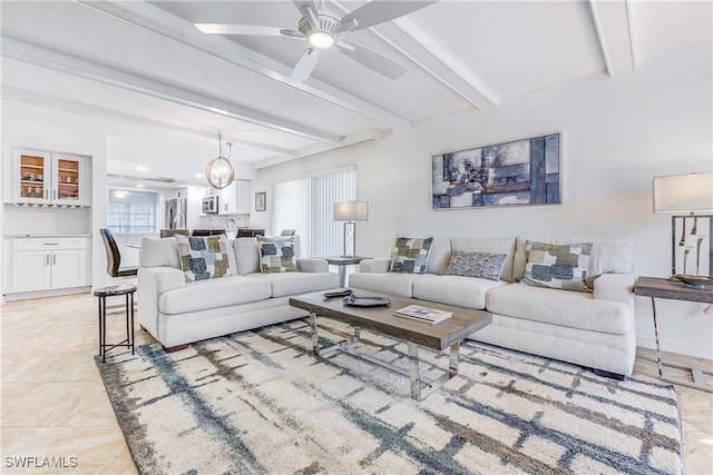 tiled living room with ceiling fan and beam ceiling