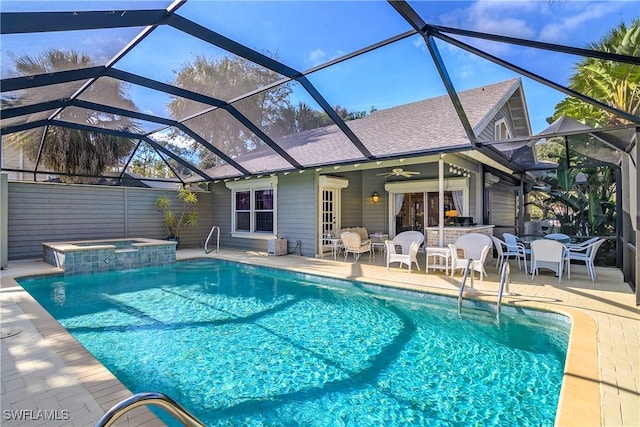 view of pool featuring an in ground hot tub, ceiling fan, a patio, and glass enclosure