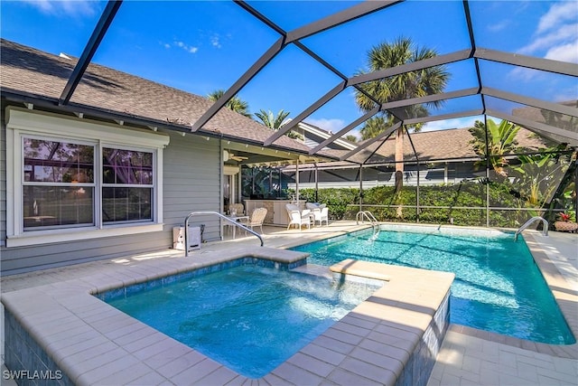 view of swimming pool with glass enclosure and a patio area