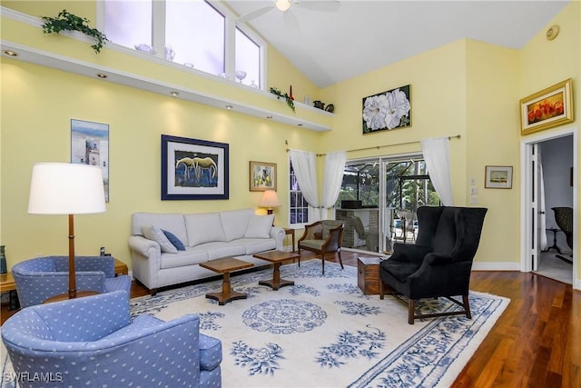 living room with ceiling fan, dark hardwood / wood-style flooring, and high vaulted ceiling