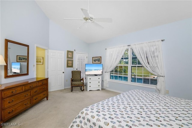 carpeted bedroom featuring high vaulted ceiling and ceiling fan