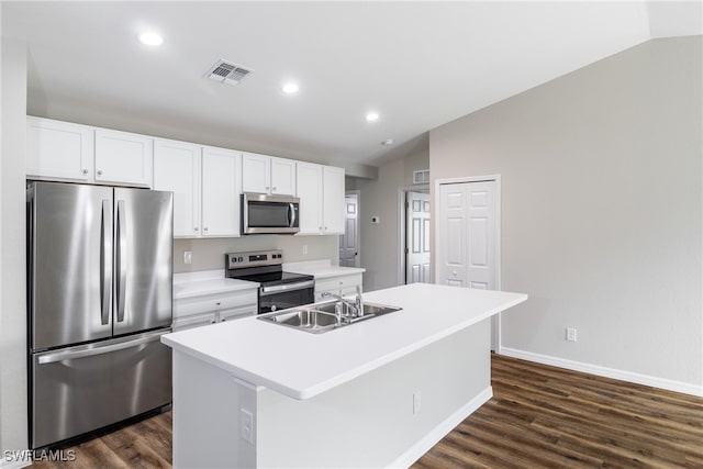 kitchen with light countertops, appliances with stainless steel finishes, a kitchen island with sink, white cabinets, and a sink