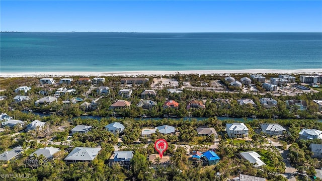 drone / aerial view featuring a view of the beach and a water view