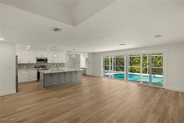 kitchen featuring stainless steel appliances, light countertops, visible vents, and white cabinetry