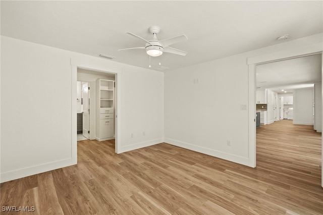 empty room with light wood-style flooring and baseboards