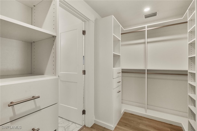 spacious closet featuring light wood-style floors and visible vents