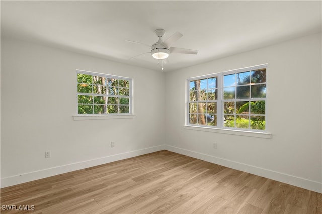 unfurnished room with light wood-style floors, baseboards, and a ceiling fan