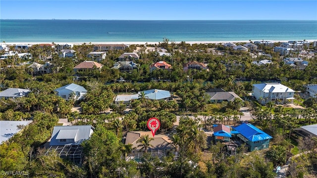 aerial view with a water view and a beach view