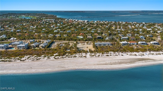 drone / aerial view featuring a water view and a beach view