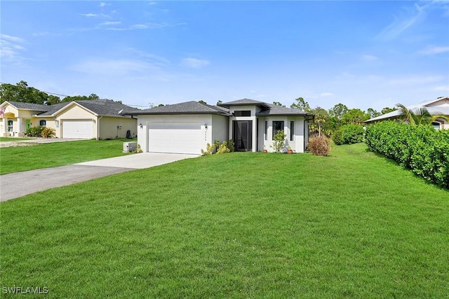 single story home featuring a garage and a front yard