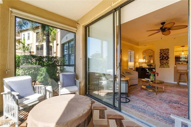 sunroom featuring a ceiling fan