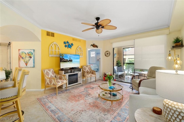 living area featuring ornamental molding, visible vents, baseboards, and a ceiling fan