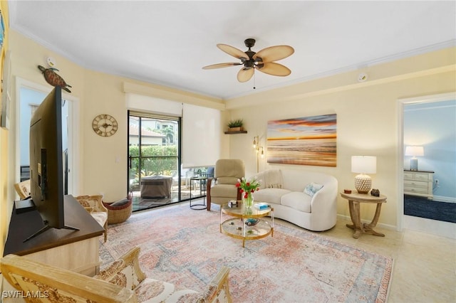 sitting room featuring baseboards, a ceiling fan, crown molding, and tile patterned floors