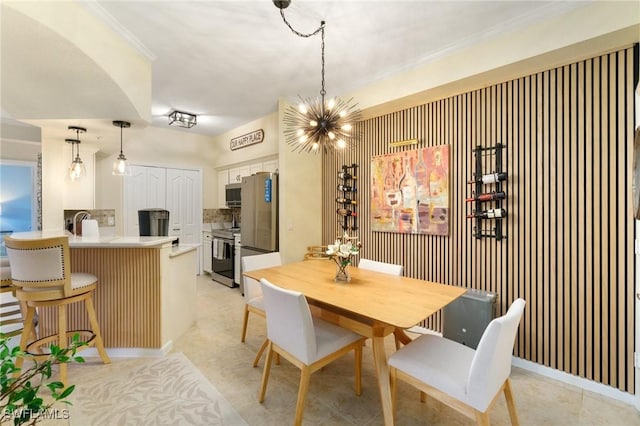 dining room featuring an inviting chandelier and crown molding