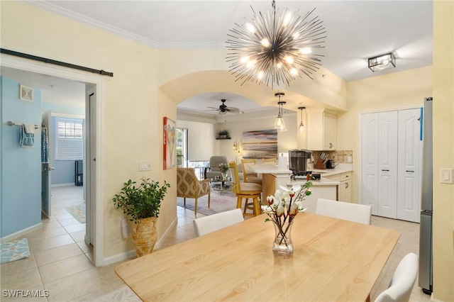 dining space with arched walkways, light tile patterned floors, a barn door, visible vents, and crown molding