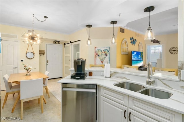 kitchen featuring a barn door, visible vents, white cabinets, dishwasher, and a sink