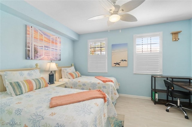 bedroom featuring a ceiling fan and baseboards