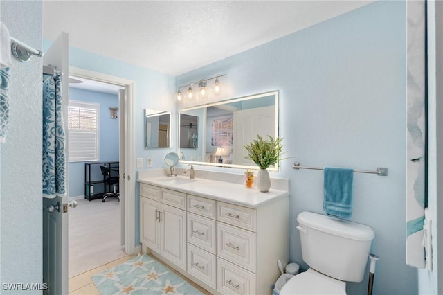 full bath with toilet, vanity, and tile patterned floors