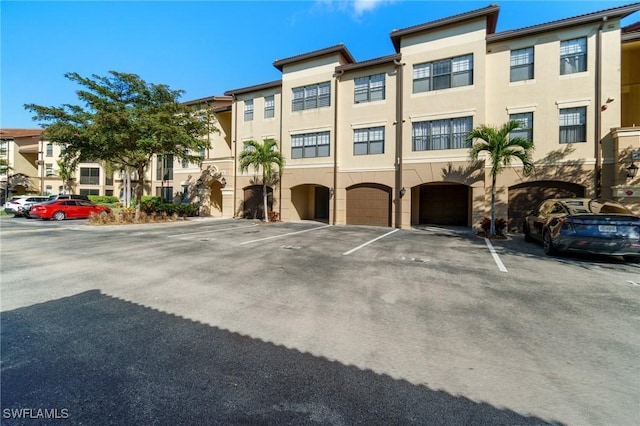 view of property featuring uncovered parking