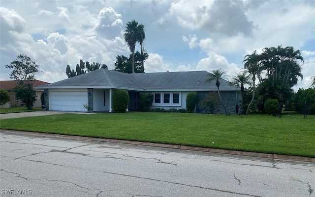 single story home featuring a garage, driveway, and a front lawn