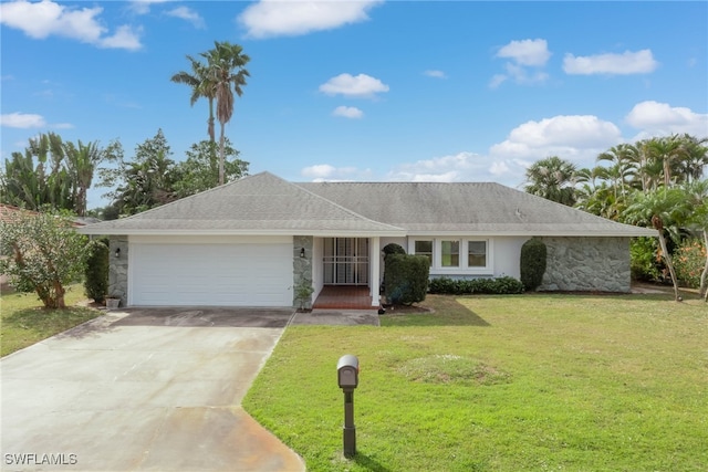 single story home featuring a garage, a shingled roof, concrete driveway, stone siding, and a front yard