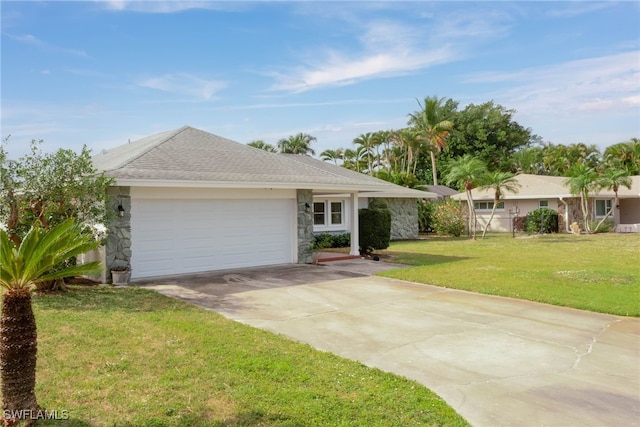 ranch-style home featuring an attached garage, a shingled roof, driveway, stone siding, and a front yard