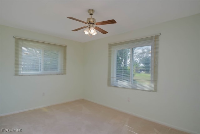 unfurnished room with a ceiling fan, carpet flooring, and baseboards