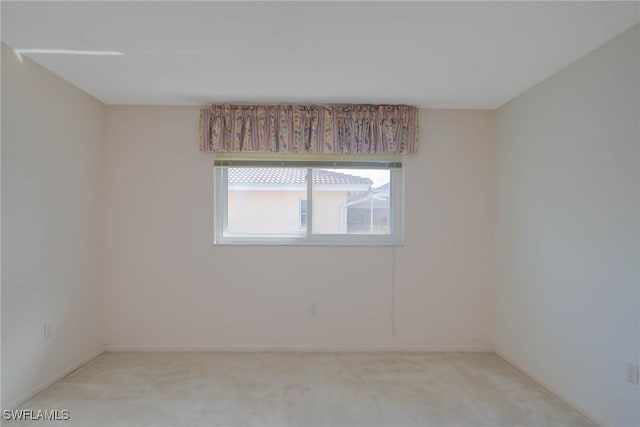 empty room featuring light carpet