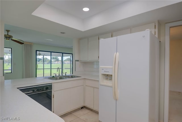 kitchen with white fridge with ice dispenser, a sink, white cabinetry, light countertops, and dishwasher