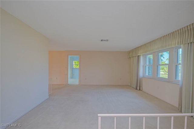 empty room with visible vents and light carpet