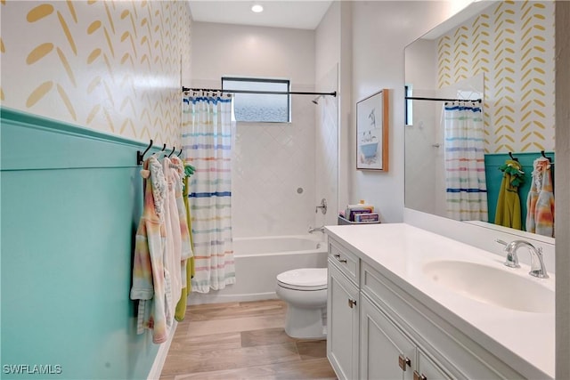 bathroom with wood finished floors, vanity, toilet, and shower / tub combo with curtain