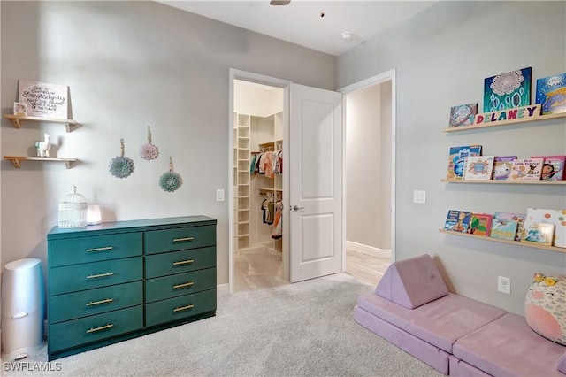 interior space with a ceiling fan and light colored carpet