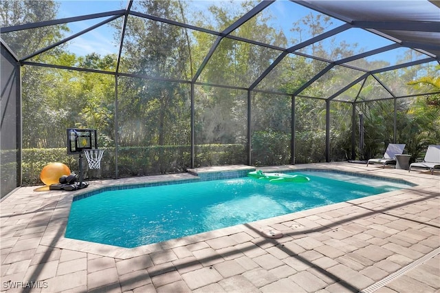 pool with a patio area and a lanai