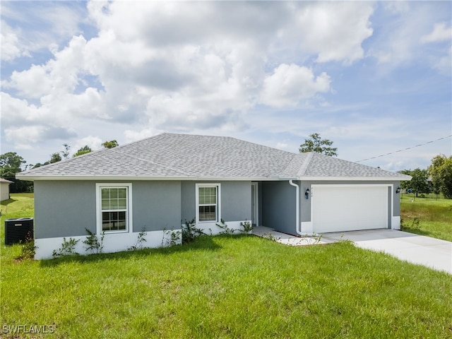 ranch-style home featuring concrete driveway, central AC unit, a front lawn, and an attached garage